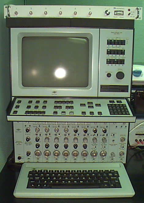 machine resembles old school computer with multiple control boards and keyboards